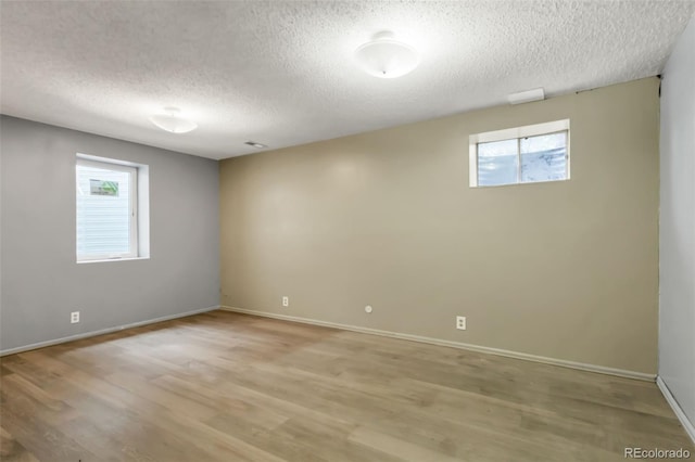 1005 S Lewiston Way, Aurora, CO 80017 - empty room with a textured ceiling, light wood-type flooring, and baseboards