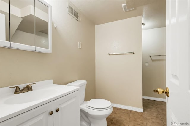 1005 S Lewiston Way, Aurora, CO 80017 - bathroom featuring toilet, vanity, tile patterned flooring, and baseboards