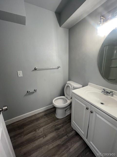 bathroom featuring hardwood / wood-style flooring, vanity, and toilet