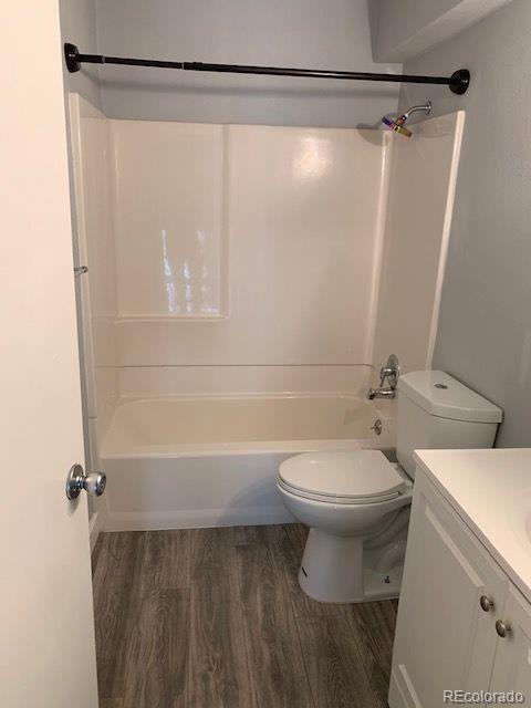 full bathroom with vanity, wood-type flooring, and shower / bathtub combination