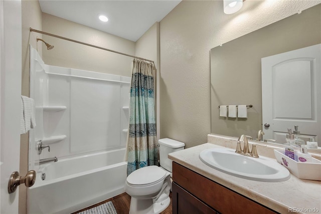 full bathroom featuring vanity, hardwood / wood-style flooring, toilet, and shower / bath combo with shower curtain