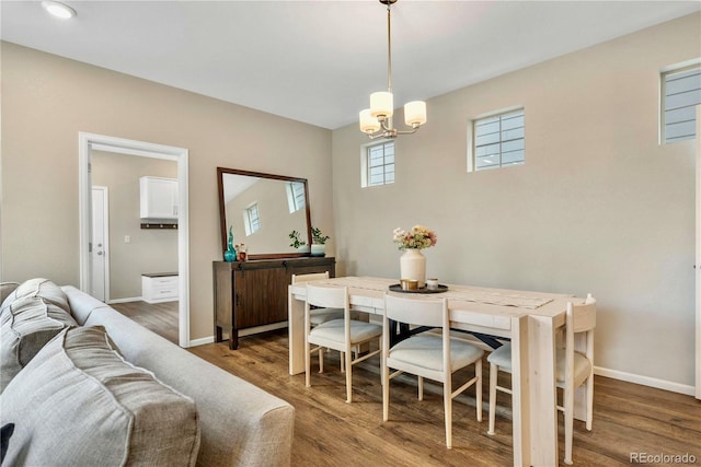 dining area with an inviting chandelier and wood-type flooring