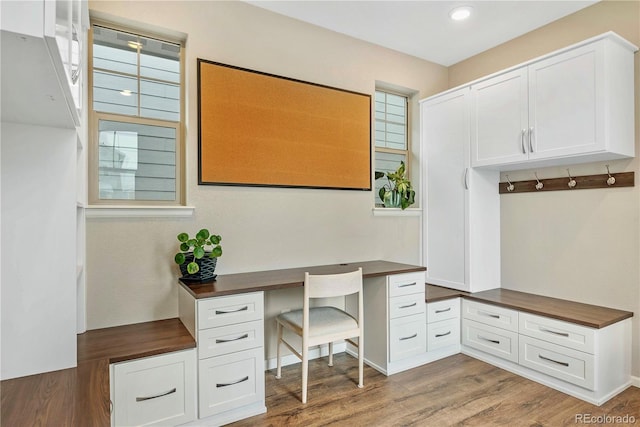 office area featuring dark hardwood / wood-style flooring and built in desk