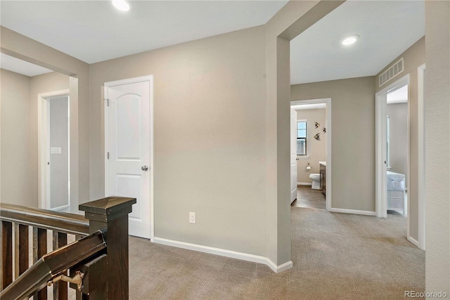 corridor with light colored carpet