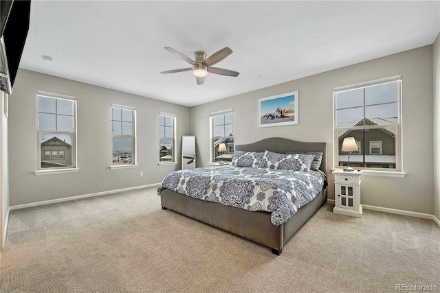 bedroom featuring ceiling fan and light carpet