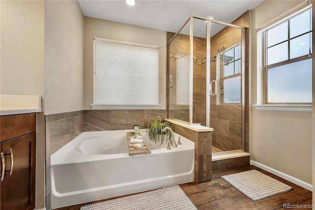 bathroom with vanity and separate shower and tub