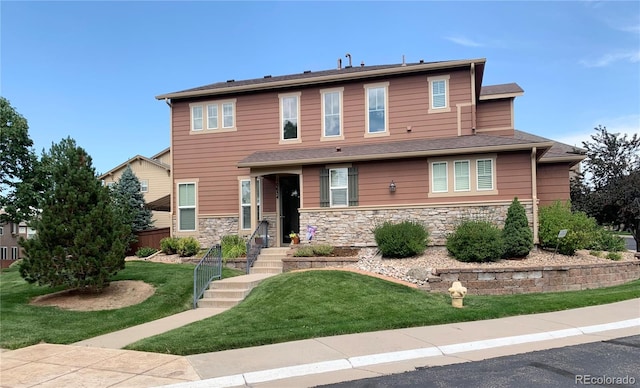 view of front of property featuring stone siding and a front yard