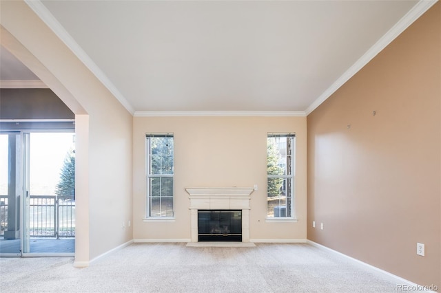 unfurnished living room featuring baseboards, a glass covered fireplace, carpet flooring, and ornamental molding