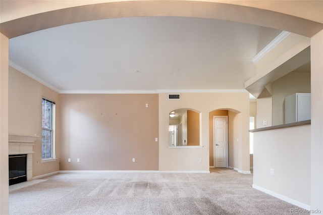 unfurnished living room with light carpet, a glass covered fireplace, and ornamental molding