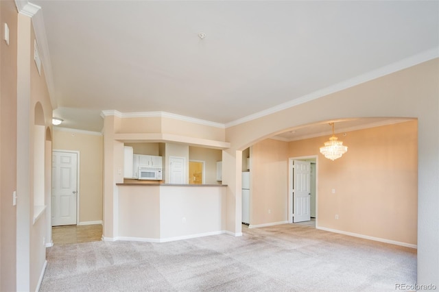 spare room featuring arched walkways, an inviting chandelier, crown molding, baseboards, and light colored carpet