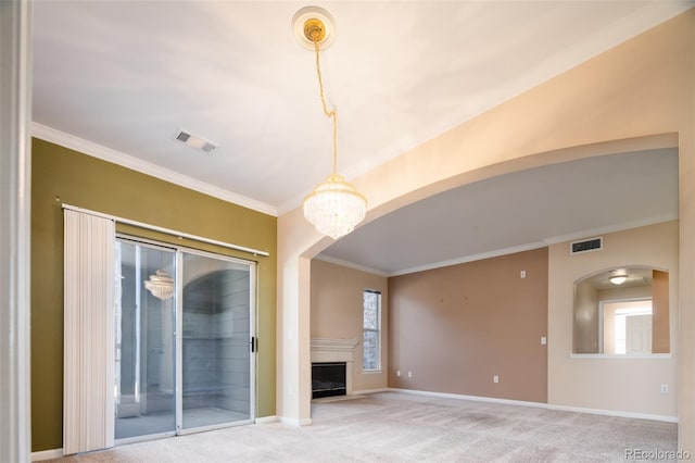 interior space with visible vents, a fireplace with flush hearth, baseboards, and carpet flooring