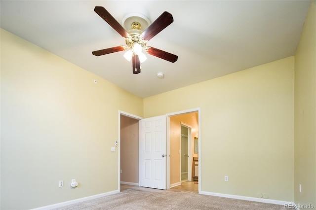 unfurnished bedroom with baseboards, light carpet, and a ceiling fan