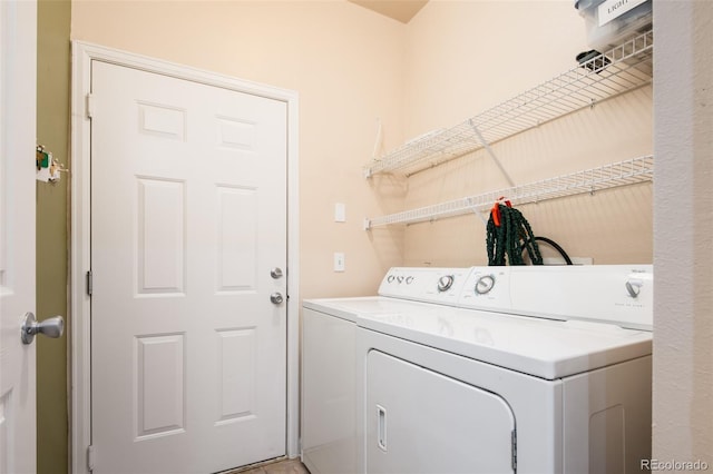 washroom featuring washing machine and dryer and laundry area