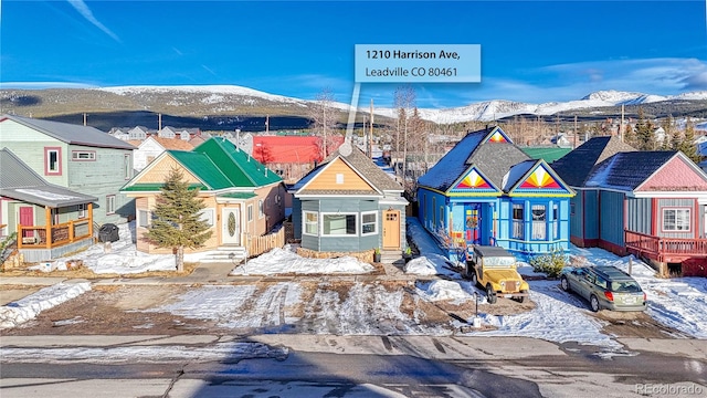 view of front of home featuring a residential view, a mountain view, and entry steps