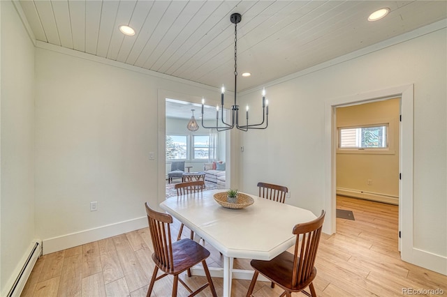 dining space with a wealth of natural light, light wood-style flooring, and baseboard heating