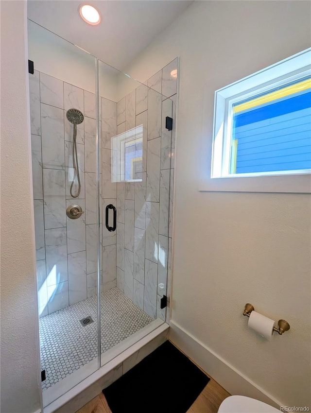 full bathroom with baseboards and a stall shower