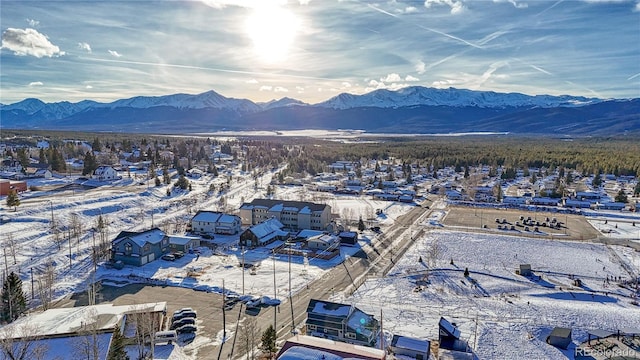 snowy aerial view with a mountain view