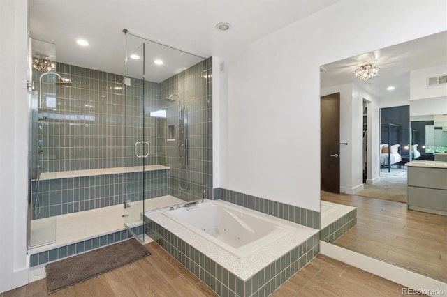 1711 Boulder St, Denver, CO 80211 - full bath featuring a shower stall, a jetted tub, wood finished floors, a chandelier, and recessed lighting