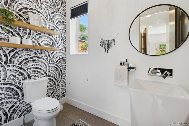 1711 Boulder St, Denver, CO 80211 - bathroom featuring toilet, baseboards, and tile patterned flooring