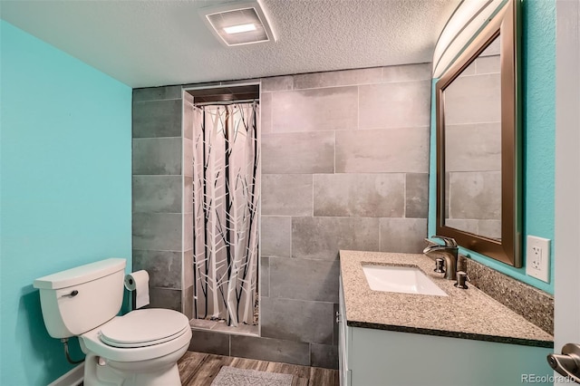 full bath with visible vents, a shower stall, toilet, and vanity