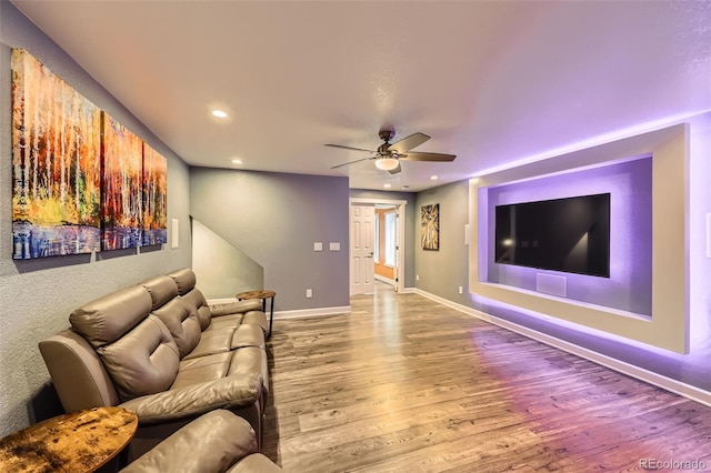 living area with a ceiling fan, baseboards, wood finished floors, and recessed lighting