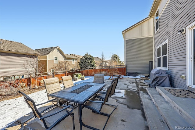 view of patio featuring a fenced backyard, a residential view, outdoor dining area, and area for grilling