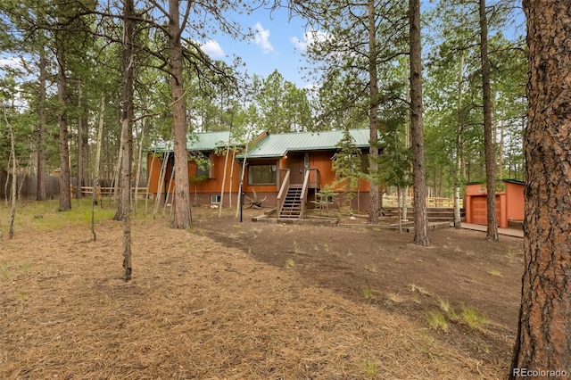 1343 Terri Ln, Woodland Park, CO 80863 - exterior space featuring a metal roof, stairs, and a storage unit