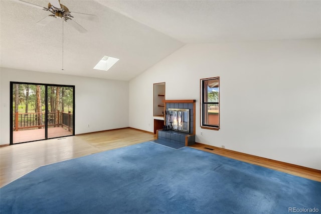 1343 Terri Ln, Woodland Park, CO 80863 - unfurnished living room with lofted ceiling, a skylight, ceiling fan, and light wood-style flooring