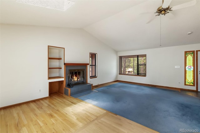 1343 Terri Ln, Woodland Park, CO 80863 - unfurnished living room featuring a glass covered fireplace, lofted ceiling, ceiling fan, and wood finished floors