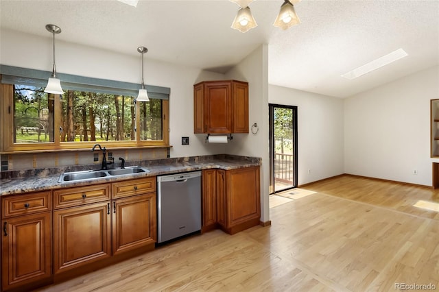 1343 Terri Ln, Woodland Park, CO 80863 - kitchen with vaulted ceiling, brown cabinetry, light wood-style floors, and dishwasher