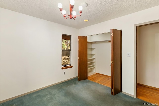 1343 Terri Ln, Woodland Park, CO 80863 - unfurnished bedroom featuring a chandelier, carpet flooring, a closet, and a textured ceiling