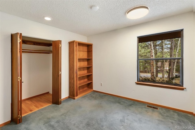 1343 Terri Ln, Woodland Park, CO 80863 - unfurnished bedroom with carpet flooring, a textured ceiling, and a closet