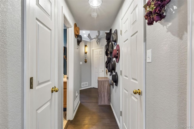 corridor with dark wood-type flooring