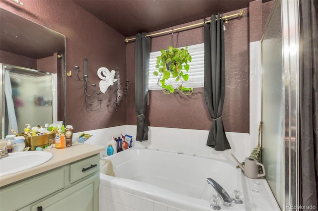 bathroom with vanity and independent shower and bath