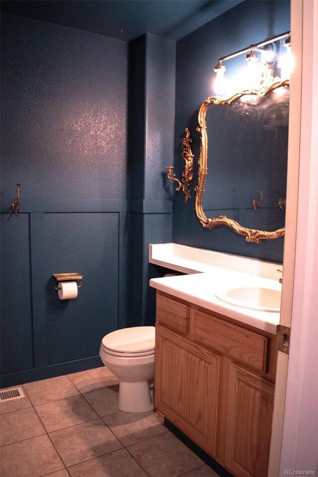 11384 Oakland Dr, Commerce City, CO 80640 - bathroom featuring vanity, toilet, and tile patterned floors