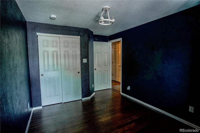 11384 Oakland Dr, Commerce City, CO 80640 - unfurnished bedroom featuring wood finished floors, baseboards, a closet, and a textured ceiling