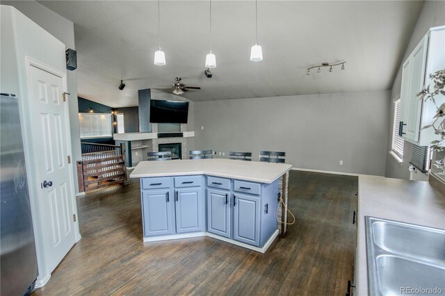 11384 Oakland Dr, Commerce City, CO 80640 - kitchen featuring open floor plan, a ceiling fan, dark wood finished floors, and light countertops