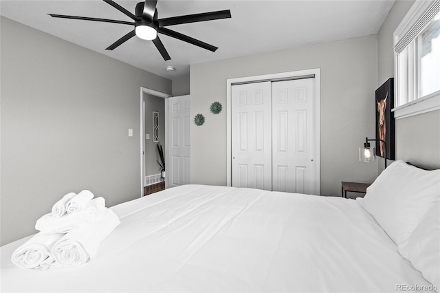 bedroom with ceiling fan and a closet