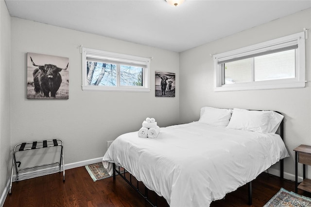 bedroom with dark hardwood / wood-style floors