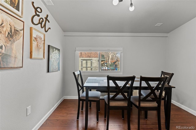 dining space with dark hardwood / wood-style floors