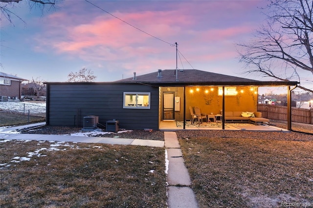 back house at dusk with a patio