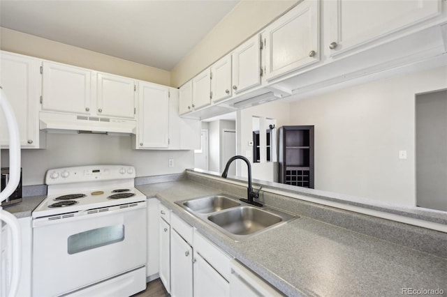 kitchen with under cabinet range hood, light countertops, white appliances, white cabinetry, and a sink