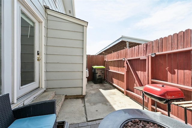 view of patio featuring grilling area and fence