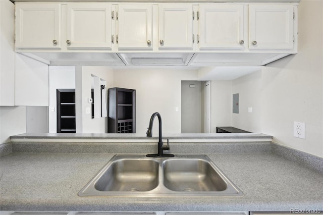 kitchen featuring a sink, light countertops, and white cabinetry