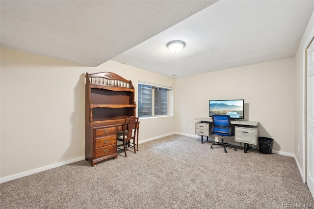 carpeted office space with baseboards and a textured ceiling