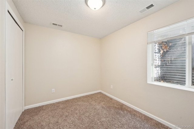 unfurnished bedroom featuring a closet, baseboards, visible vents, and carpet floors