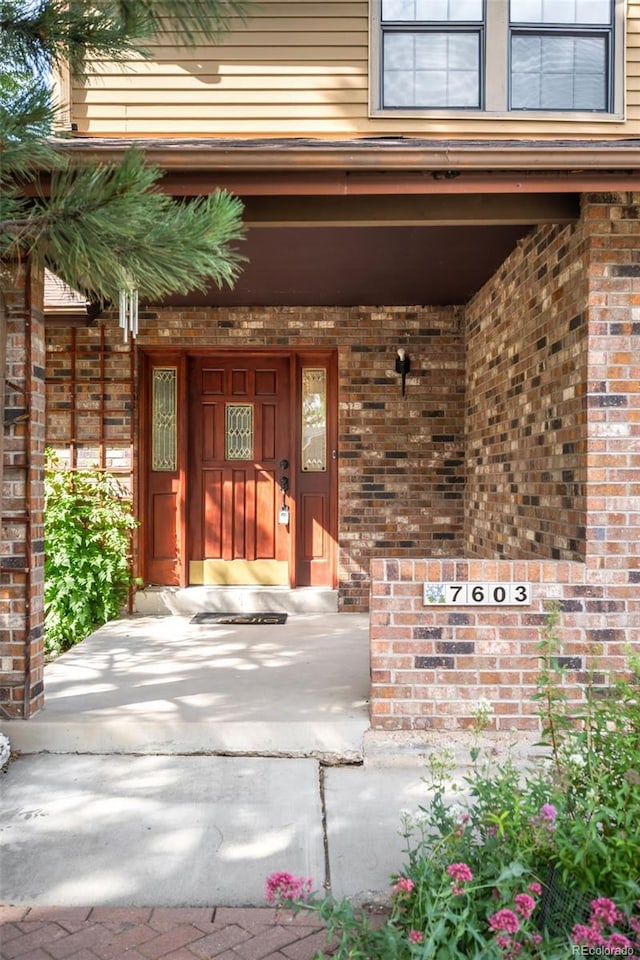 7603 W Coal Mine Pl, Littleton, CO 80128 - property entrance with brick siding and covered porch