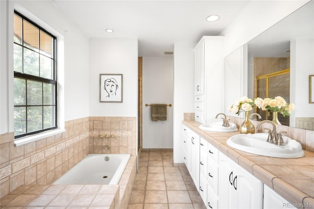 7603 W Coal Mine Pl, Littleton, CO 80128 - full bathroom with double vanity, a bath, a shower stall, and tile patterned floors