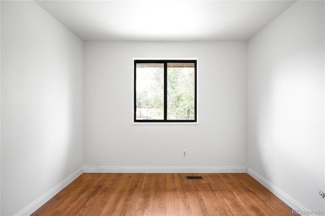 7603 W Coal Mine Pl, Littleton, CO 80128 - spare room featuring wood finished floors and baseboards