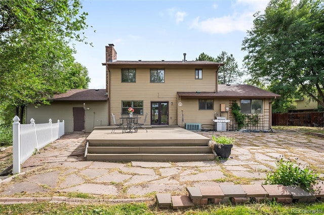 7603 W Coal Mine Pl, Littleton, CO 80128 - back of house with a chimney and a deck